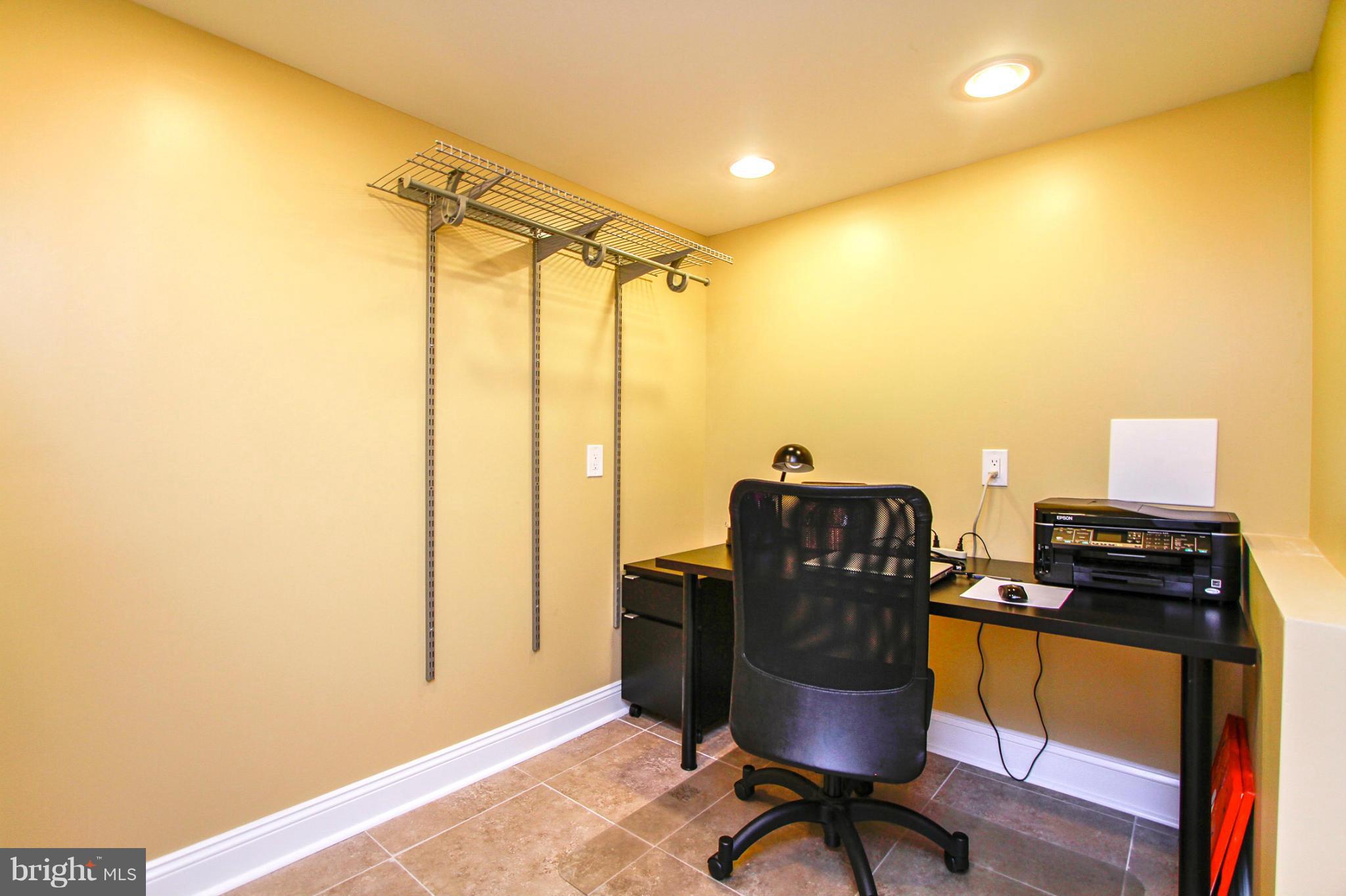 6202 Collinsway Road Baltimore, MD 21228 - Photo 26 of 30 a view of workspace with wooden floor windows