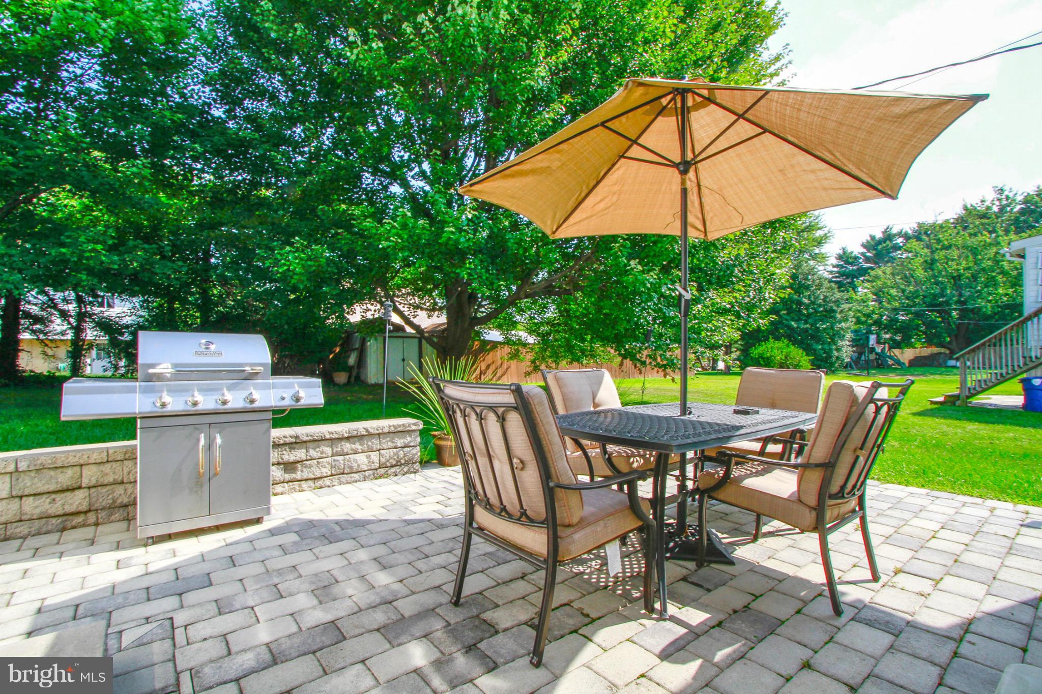 6202 Collinsway Road Baltimore, MD 21228 - Photo 27 of 30 a view of a patio with table and chairs under an umbrella