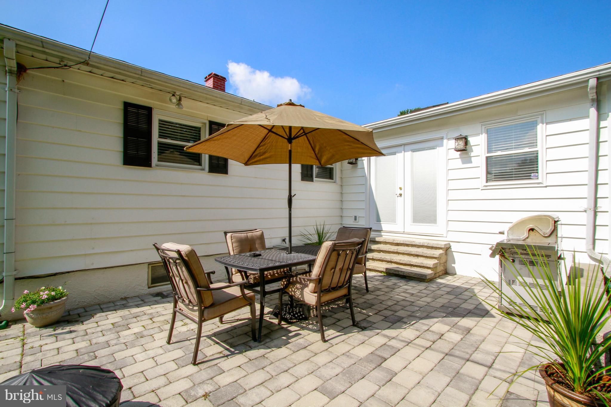 6202 Collinsway Road Baltimore, MD 21228 - Photo 28 of 30 a view of a patio with a table and chairs under an umbrella
