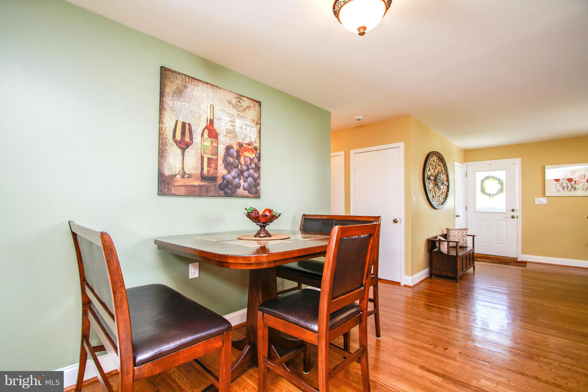 6202 Collinsway Road Baltimore, MD 21228 - Photo 6 of 30 a view of a dining room with furniture and wooden floor