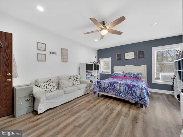 a spacious bedroom with a bed and a couch