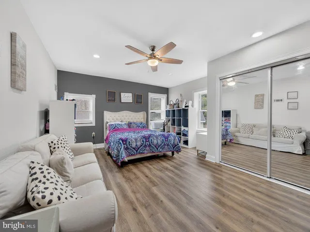 a bedroom with furniture and wooden floor