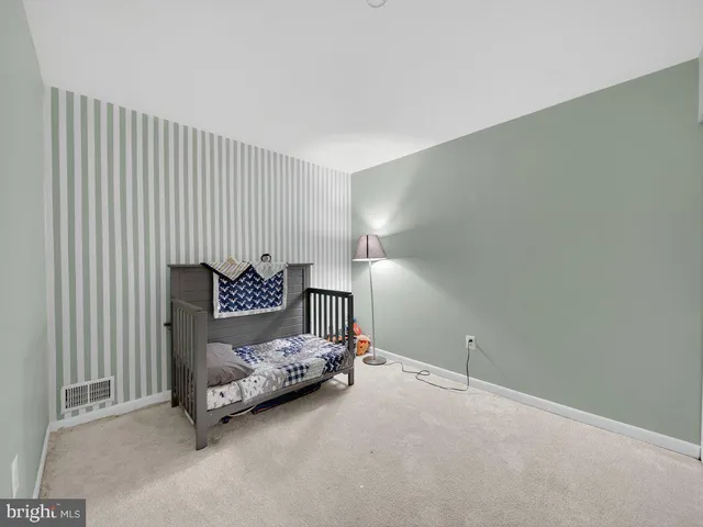 a bedroom with a bed and a chair