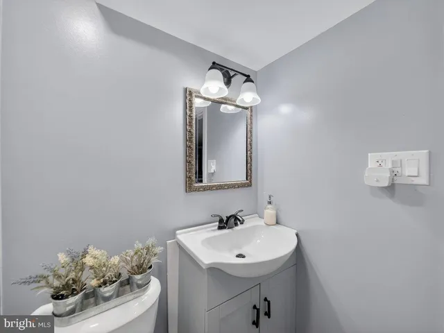 a bathroom with a sink mirror and vanity