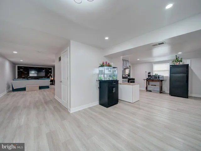 a view of kitchen with kitchen island and stainless steel appliances