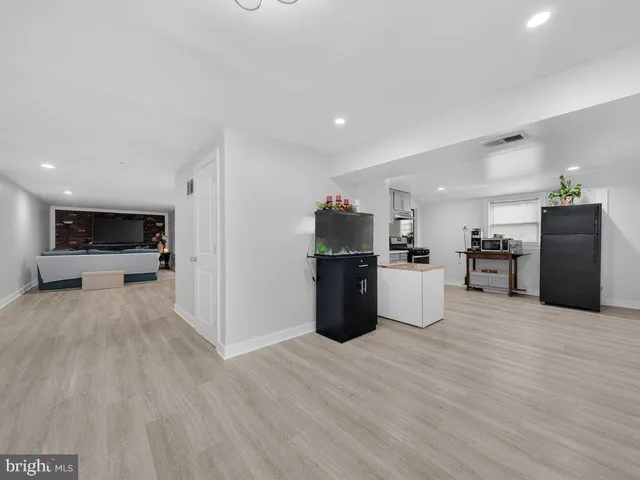 a view of kitchen with refrigerator and wooden floor