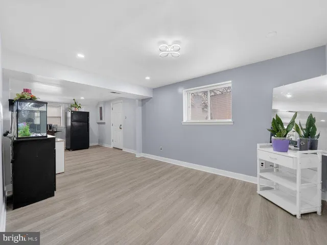 a view of a kitchen with a sink and a refrigerator