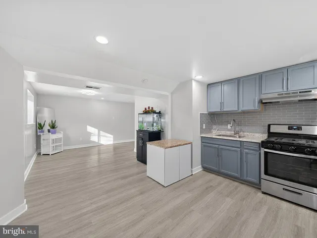 a kitchen with a sink cabinets and stainless steel appliances