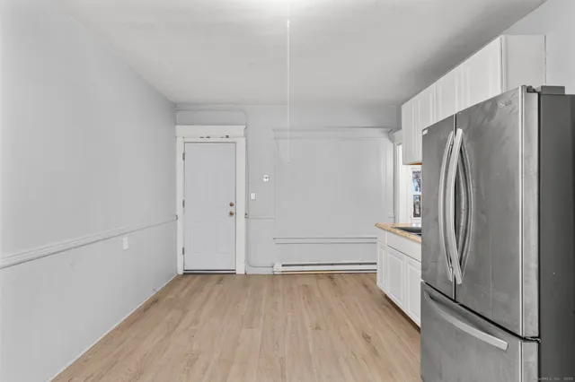 a view of a kitchen with a refrigerator and an empty refrigerator