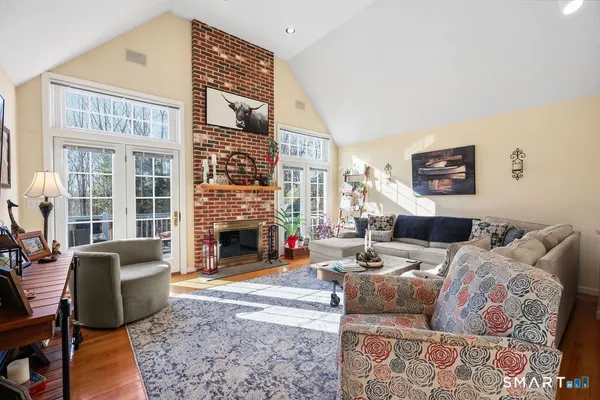 a living room with furniture large window and a fireplace