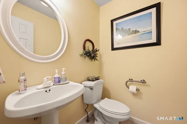 a bathroom with a toilet a sink and a mirror