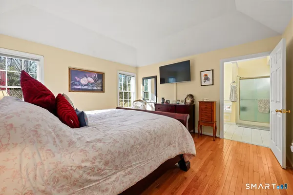a bedroom with a bed and a flat screen tv