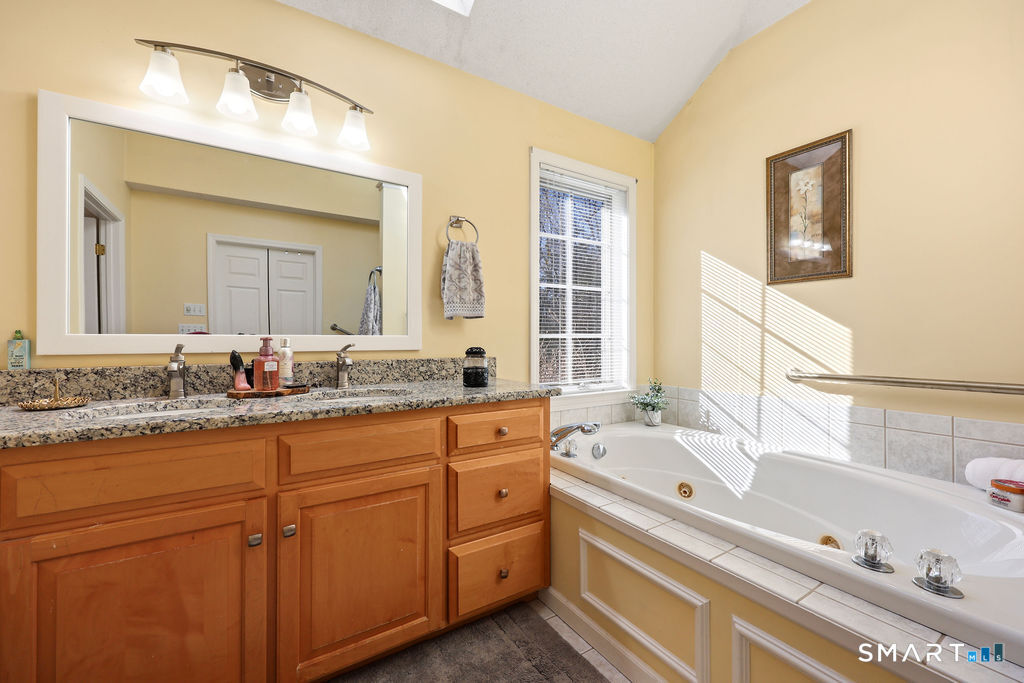 73 High Valley Drive Canton, CT 06019 - Photo 25 of 37 a bathroom with a tub a sink and mirror