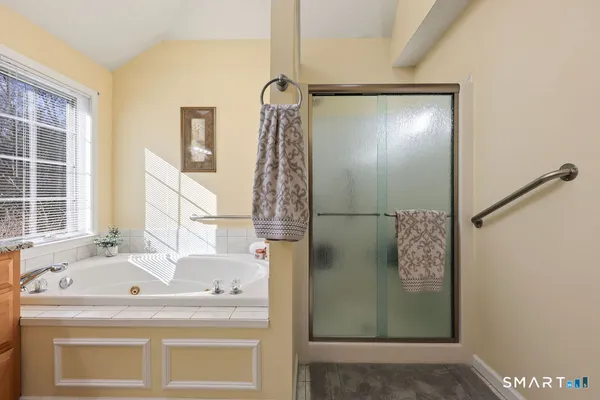 a bathroom with a tub and a shower