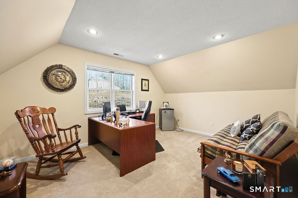 73 High Valley Drive Canton, CT 06019 - Photo 27 of 37 a living room with furniture a clock and a window