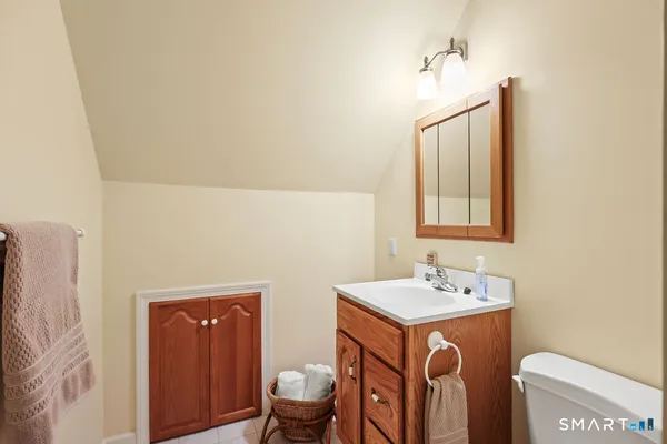 a bathroom with a sink a toilet and mirror