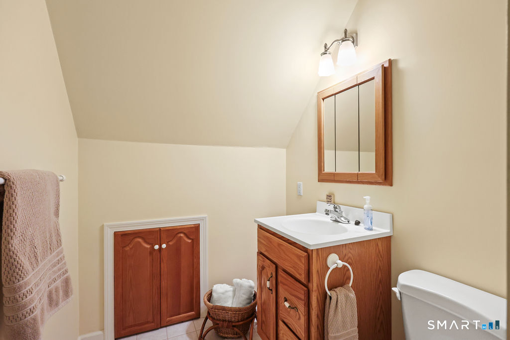 73 High Valley Drive Canton, CT 06019 - Photo 29 of 37 a bathroom with a sink a toilet and mirror