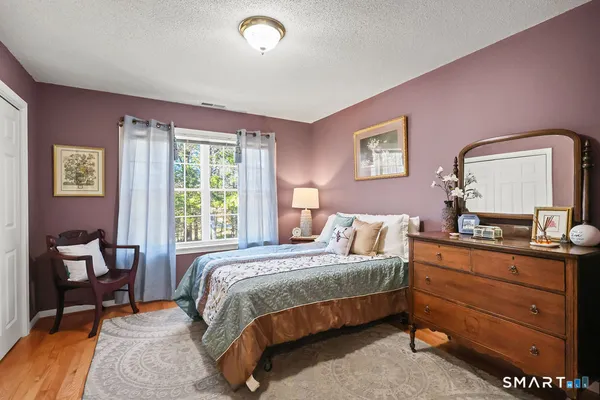 a bedroom with a bed and a dresser in it