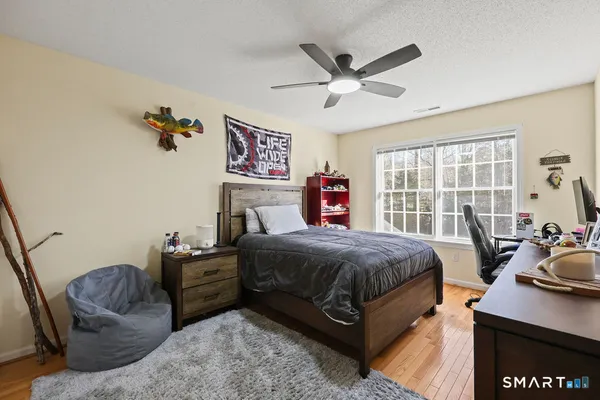 a bedroom with a bed window and couch