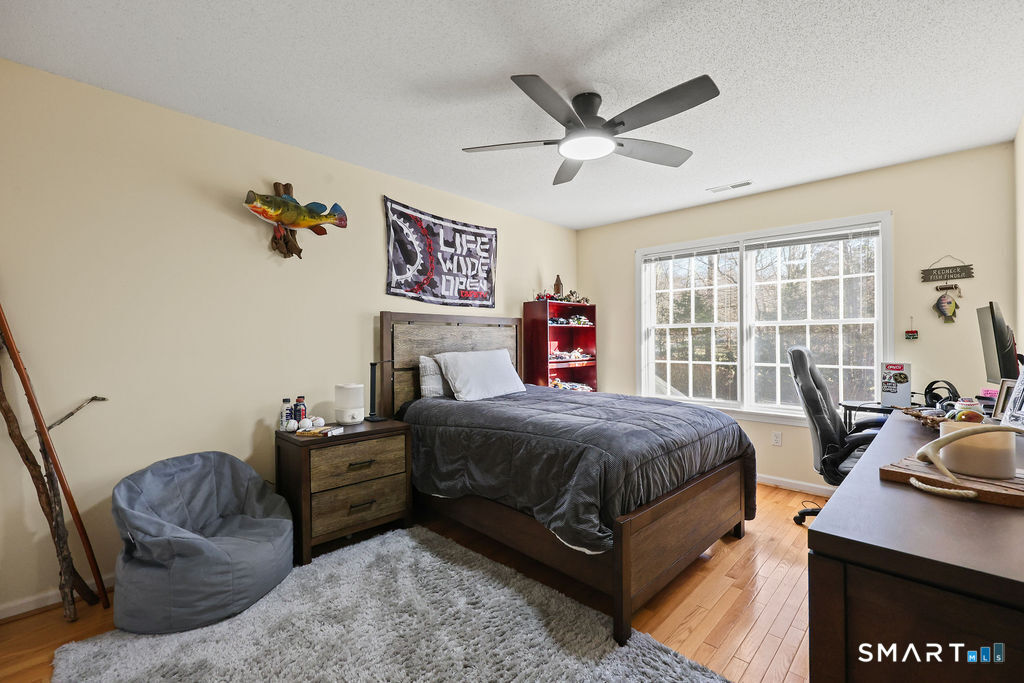 73 High Valley Drive Canton, CT 06019 - Photo 33 of 37 a bedroom with a bed window and couch