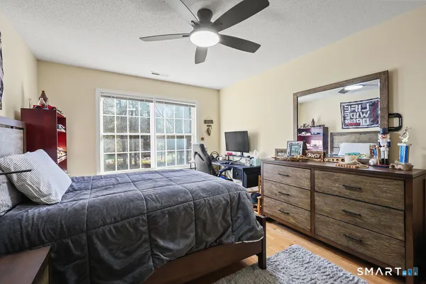 a bedroom with a bed and a large window