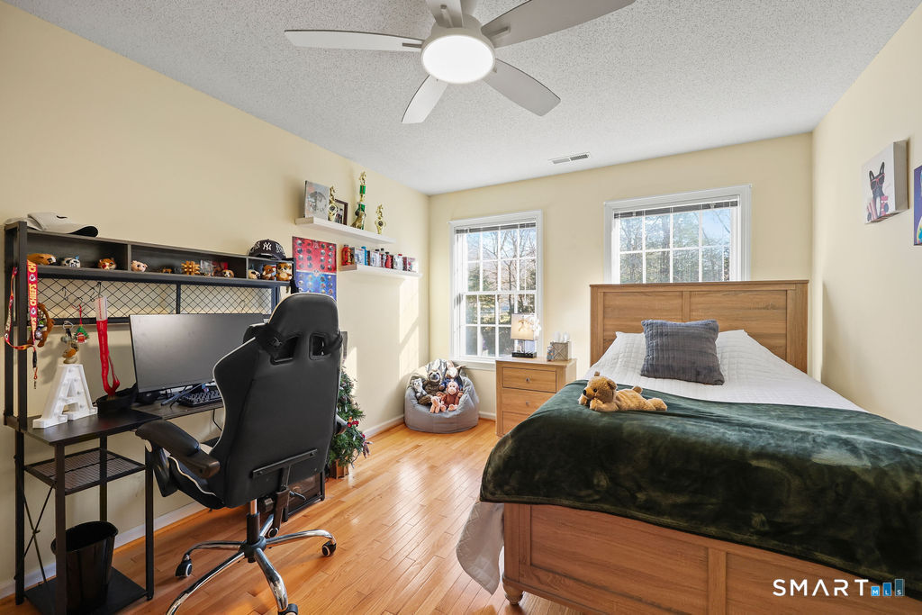 73 High Valley Drive Canton, CT 06019 - Photo 36 of 37 a bedroom with a bed and wooden floor