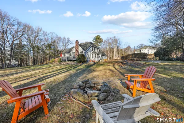 a backyard of a house with table and chairs
