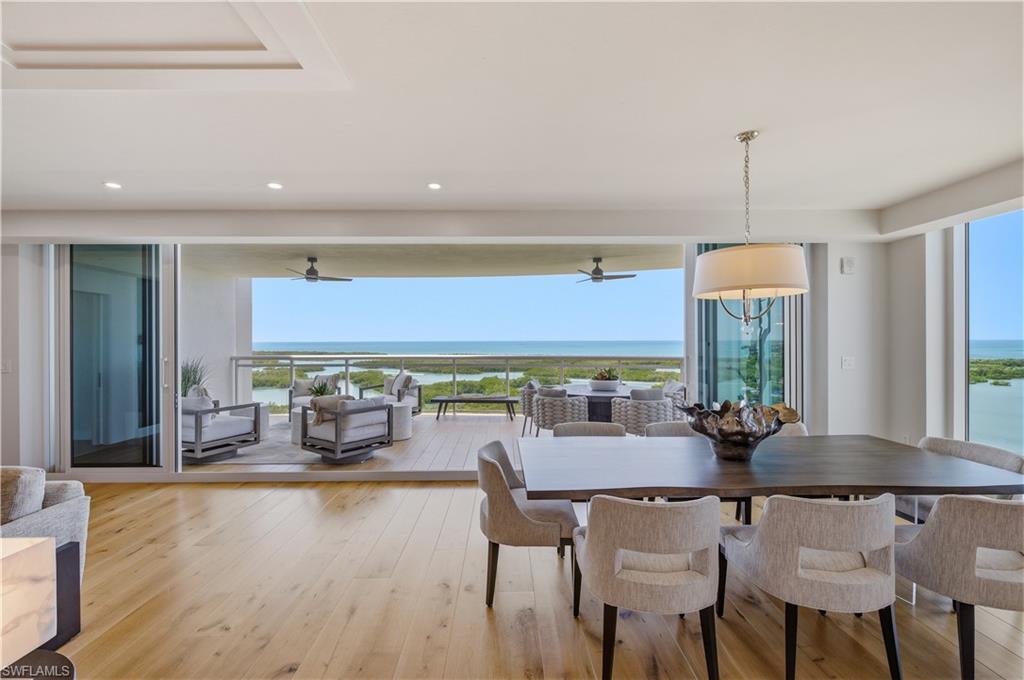 13925 Old Coast Road, Unit 1706 Naples, FL 34110 - Photo 11 of 37 a dining hall with furniture window and wooden floor