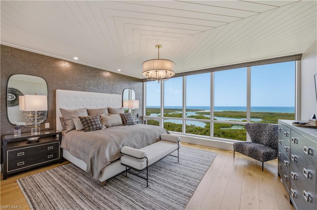 13925 Old Coast Road, Unit 1706 Naples, FL 34110 - Photo 12 of 37 a bedroom with a bed and a couch