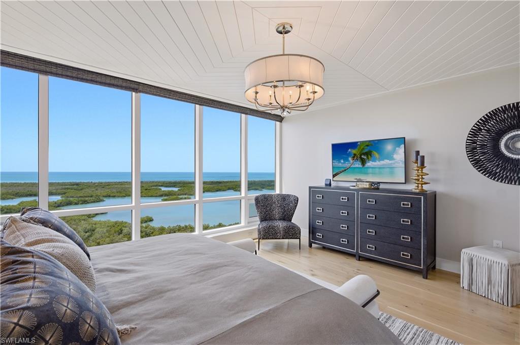 13925 Old Coast Road, Unit 1706 Naples, FL 34110 - Photo 14 of 37 a room with furniture and a large window