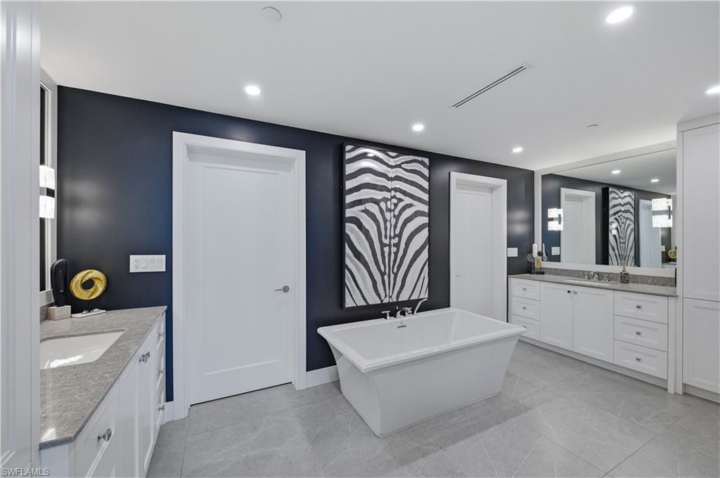 13925 Old Coast Road, Unit 1706 Naples, FL 34110 - Photo 15 of 37 a spacious bathroom with a sink a vanity and mirror