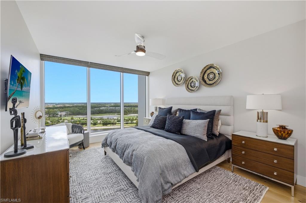 13925 Old Coast Road, Unit 1706 Naples, FL 34110 - Photo 19 of 37 a bedroom with a bed and a large window with outer view