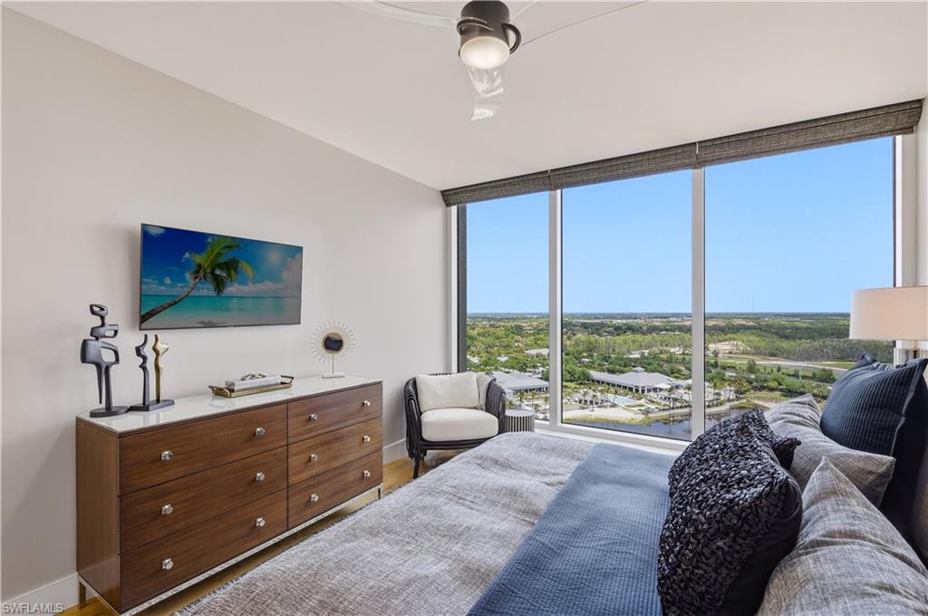 13925 Old Coast Road, Unit 1706 Naples, FL 34110 - Photo 20 of 37 a living room with furniture and large windows