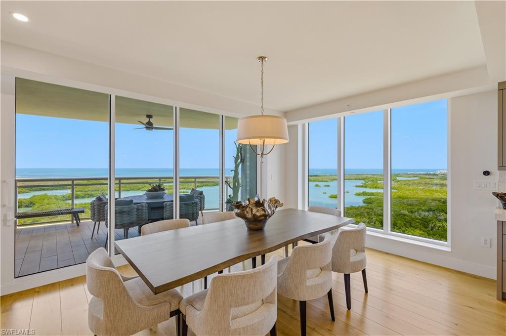 13925 Old Coast Road, Unit 1706 Naples, FL 34110 - Photo 2 of 37 a dining room with furniture window and wooden floor