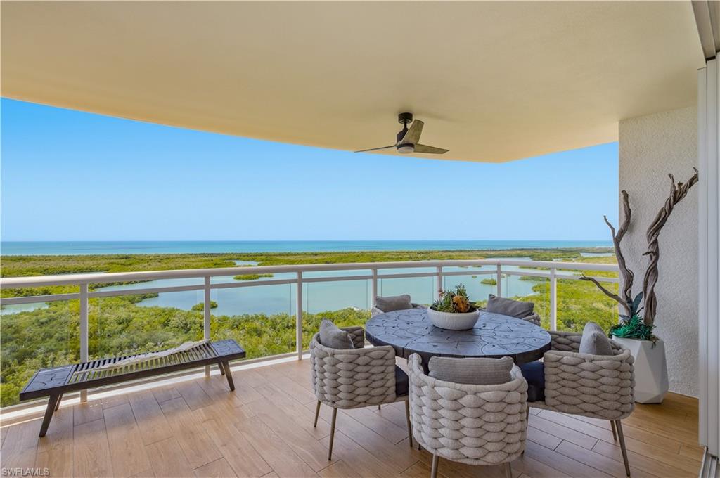 13925 Old Coast Road, Unit 1706 Naples, FL 34110 - Photo 25 of 37 a view of swimming pool with a table and chairs