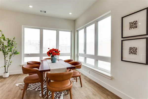a dining room with furniture and wooden floor