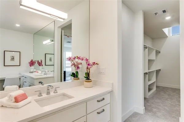 a bathroom with a sink vanity and a mirror