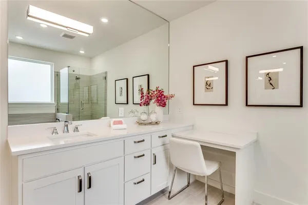 a bathroom with a sink vanity and a mirror