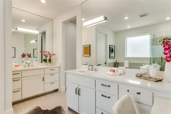 a bathroom with a double vanity sink mirror and