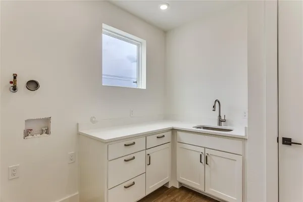 a kitchen with cabinets and window