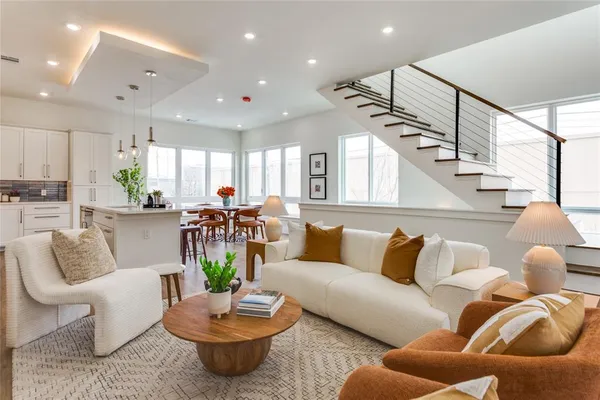 a living room with furniture potted plant and a view of kitchen