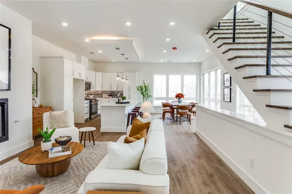 a living room with furniture kitchen and a table