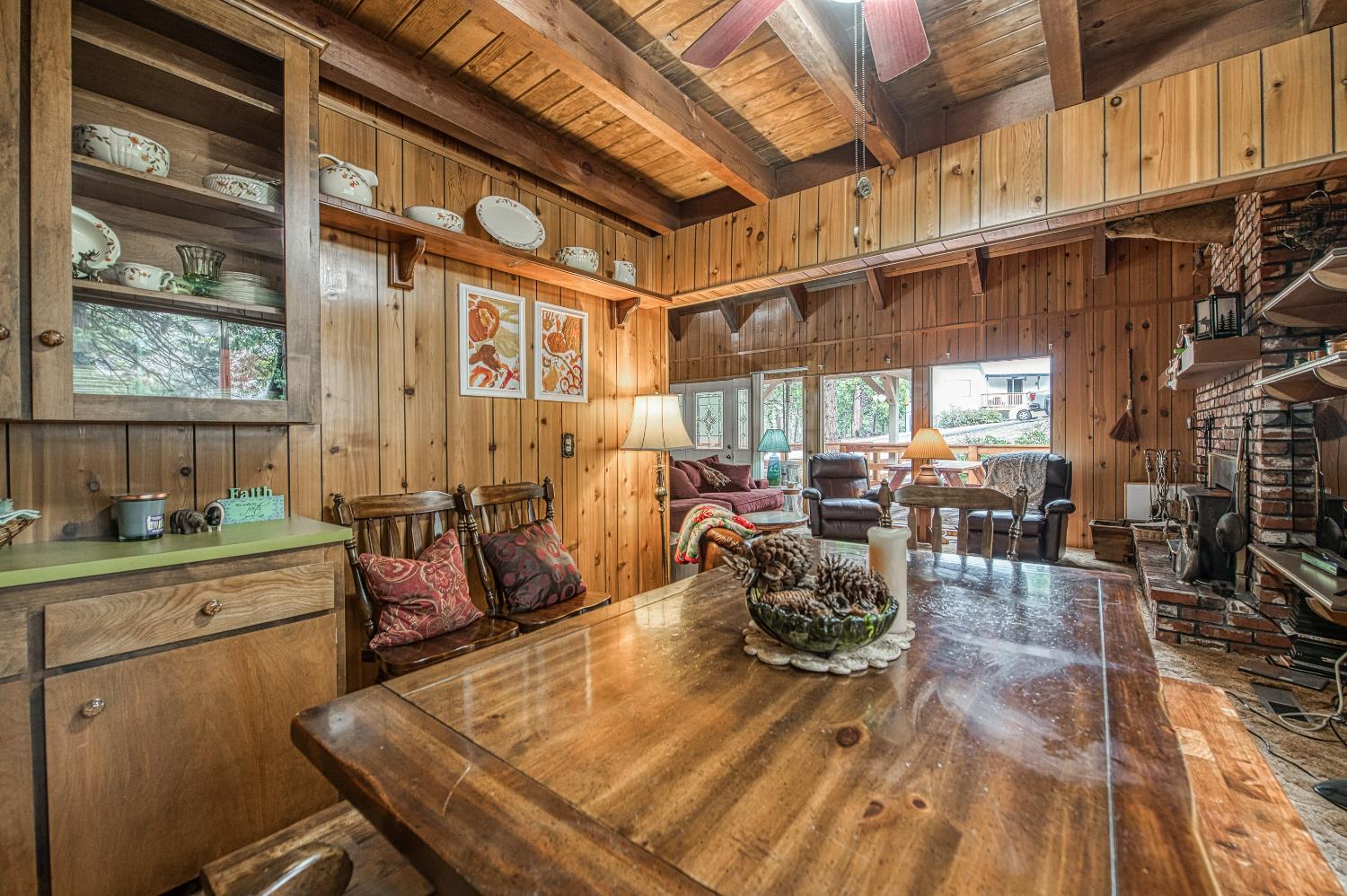 42303 Hanging Branch Road Shaver Lake, CA 93664 - Photo 14 of 39 a view of a dining room with furniture a chandelier and wooden floor