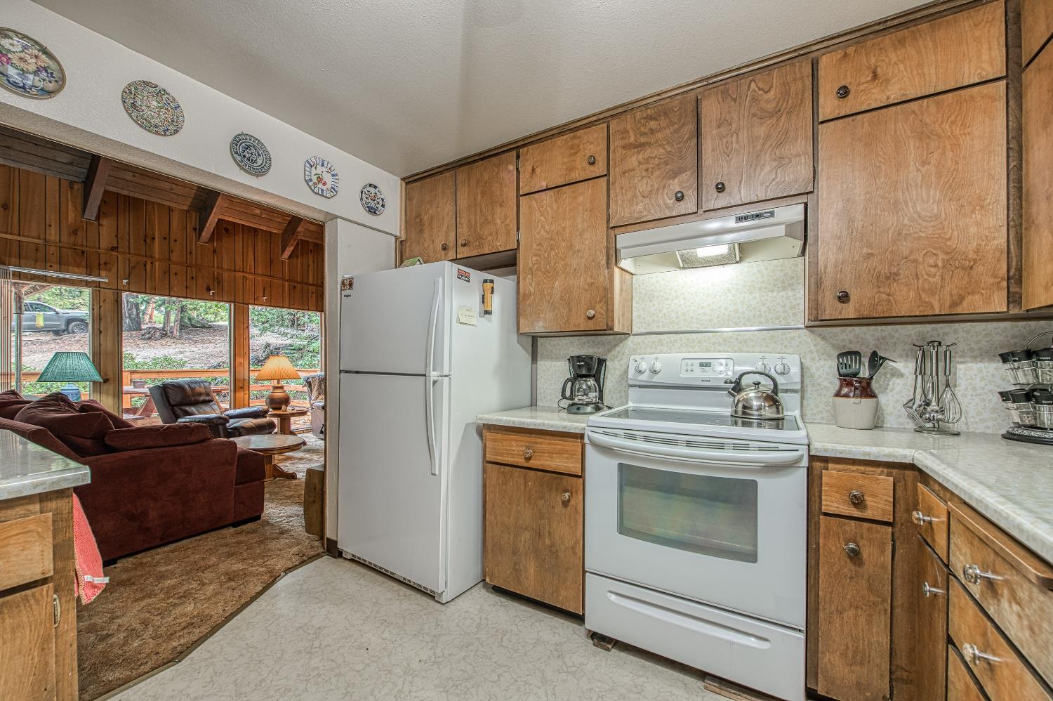 42303 Hanging Branch Road Shaver Lake, CA 93664 - Photo 18 of 39 a kitchen with stainless steel appliances granite countertop a refrigerator sink stove and white cabinets