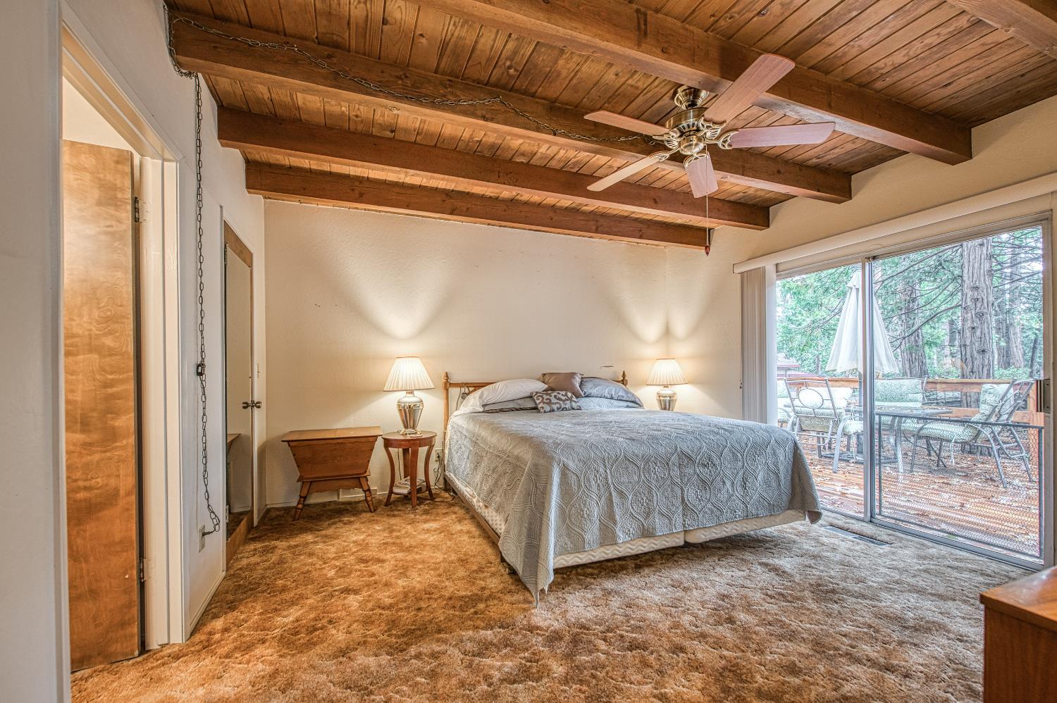 42303 Hanging Branch Road Shaver Lake, CA 93664 - Photo 21 of 39 a spacious bedroom with a bed and large window with balcony view