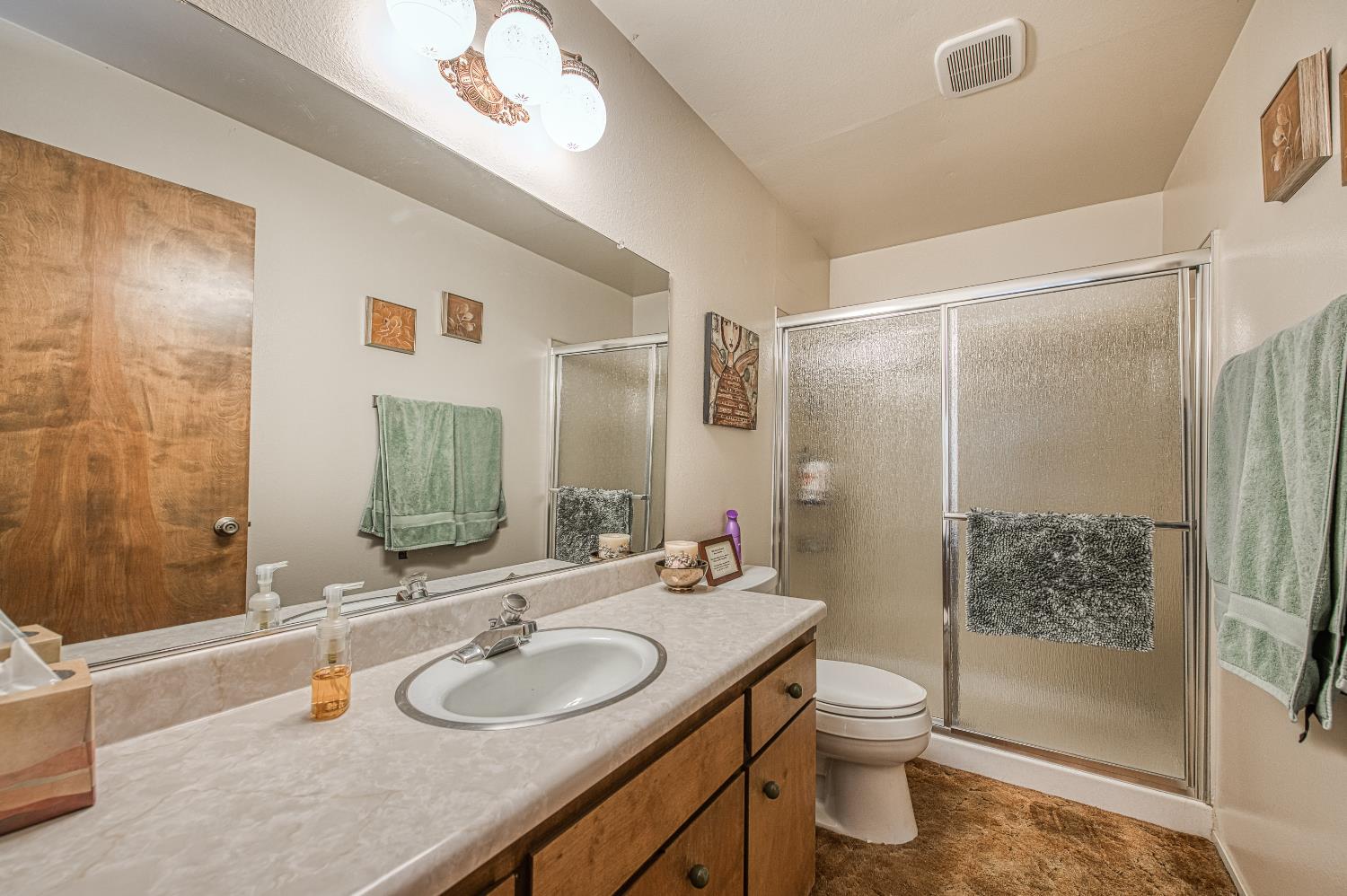 42303 Hanging Branch Road Shaver Lake, CA 93664 - Photo 23 of 39 a bathroom with a granite countertop sink toilet and shower