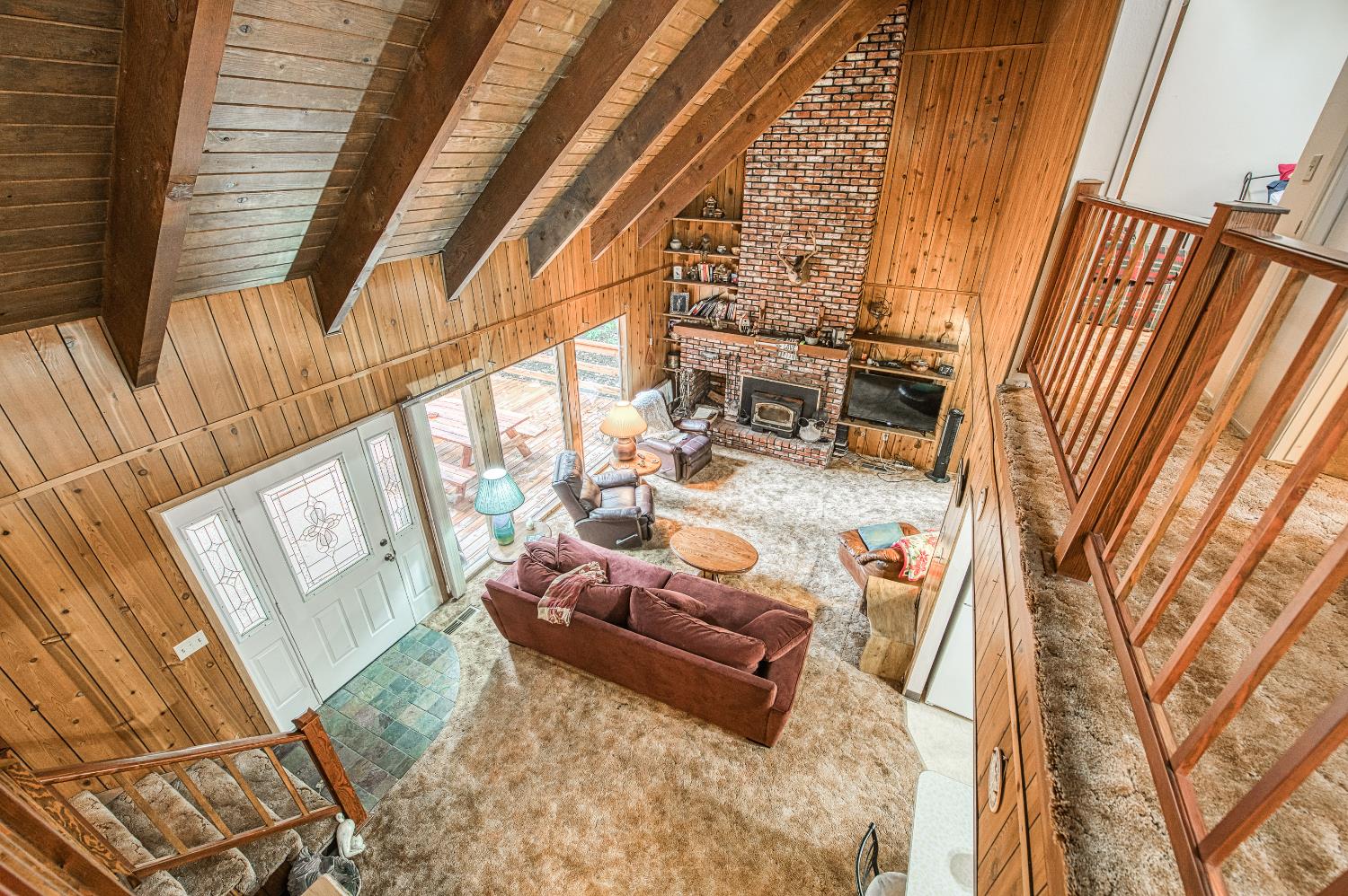 42303 Hanging Branch Road Shaver Lake, CA 93664 - Photo 24 of 39 a living room with furniture and a floor to ceiling window
