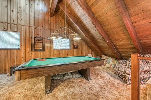 a room with pool table and window