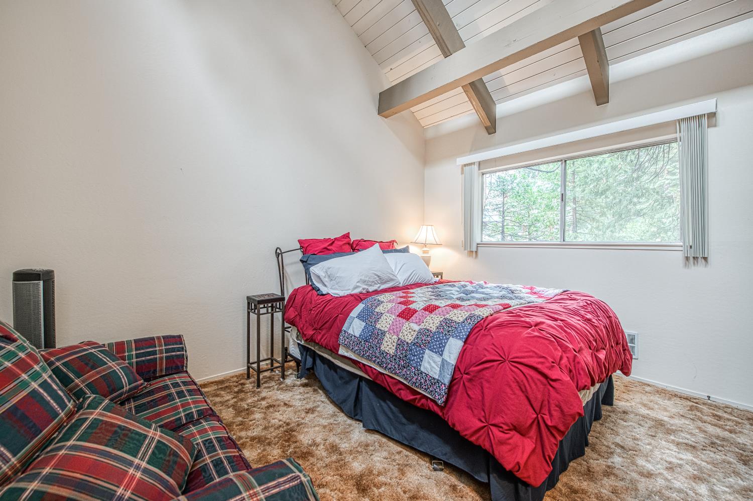 42303 Hanging Branch Road Shaver Lake, CA 93664 - Photo 33 of 39 a bedroom with a bed and a chandelier