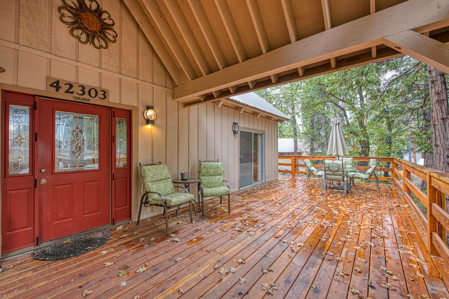 42303 Hanging Branch Road Shaver Lake, CA 93664 - Photo 36 of 39 a view of a patio with table and chairs and wooden floor